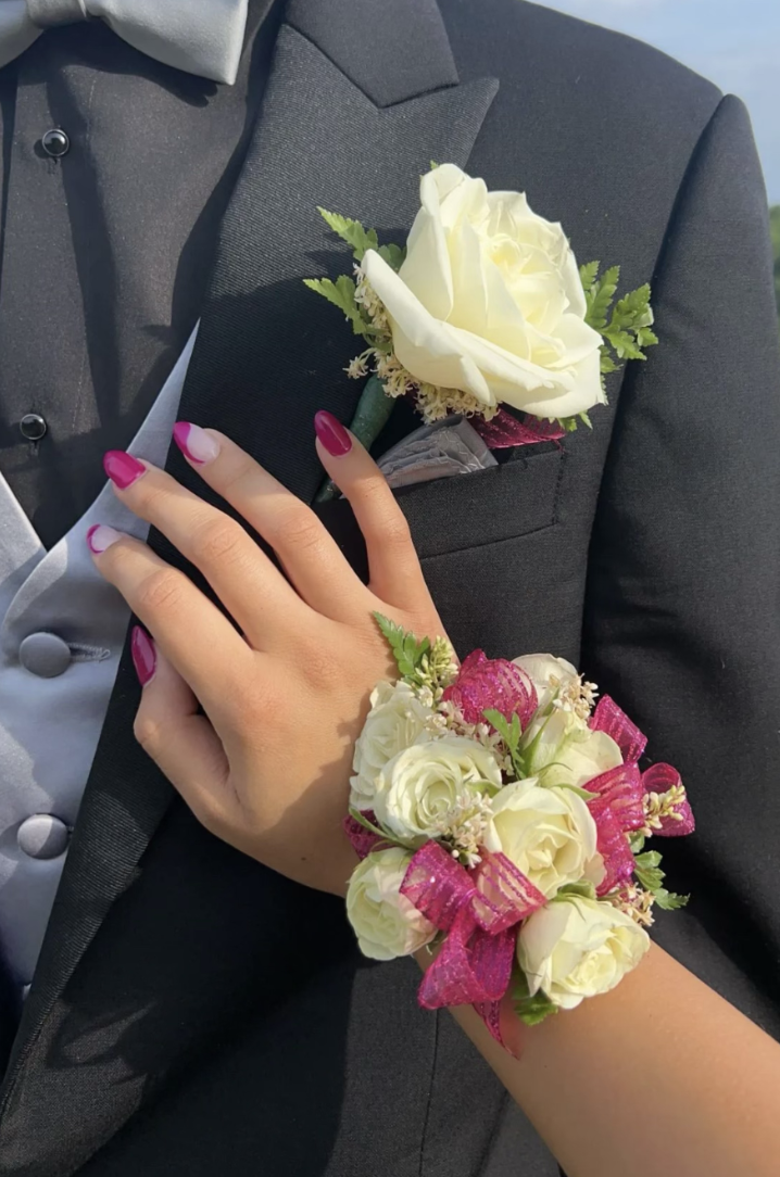 A corsage and boutonniere that match with ribbon and roses; these flowers are from Preston Flowers. 
